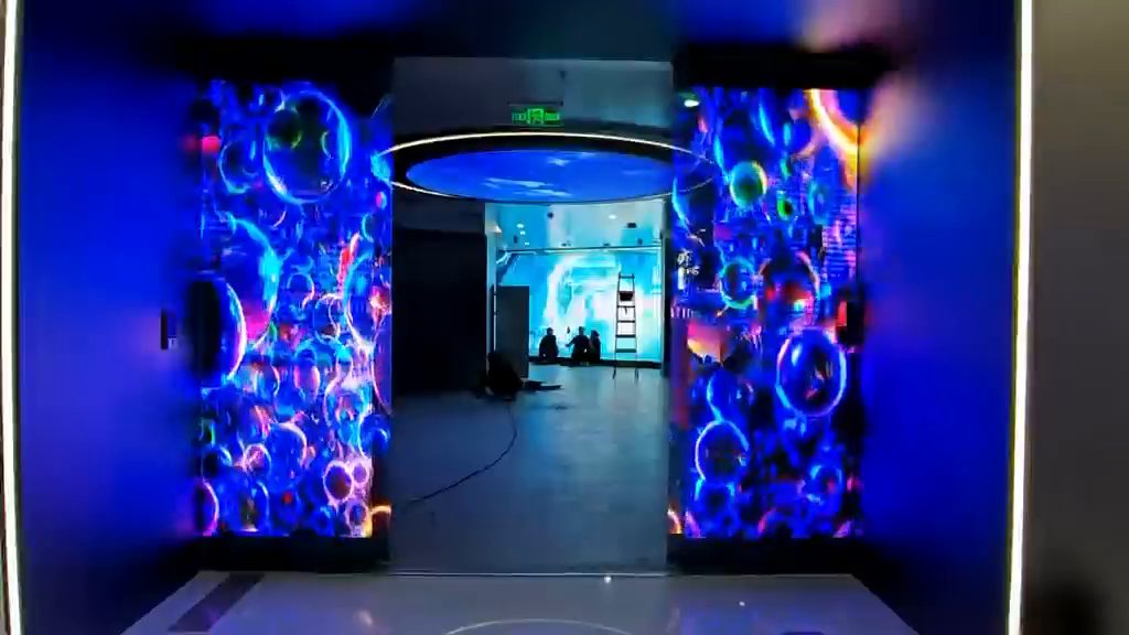 Curved immersive tunnel lined with flexible transparent LED film
